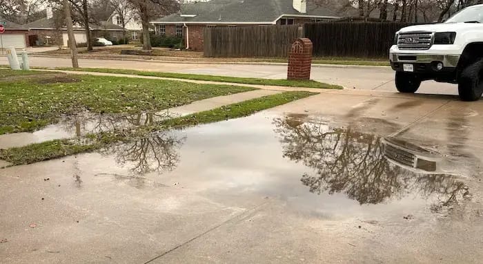 Sinking driveway causing water to pool Sinking driveway causing water to pool